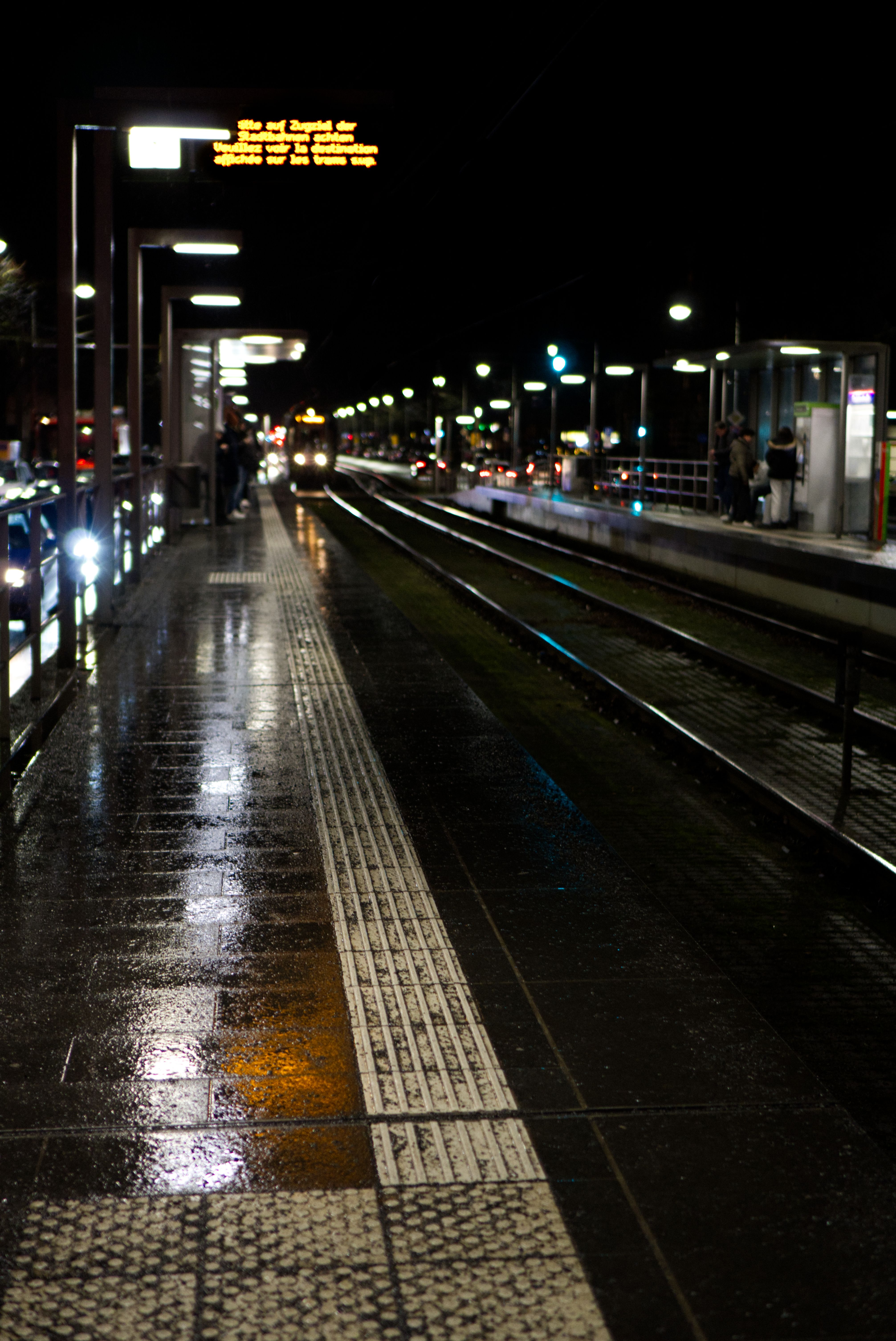 A train incoming at Sophie's home train stop in the rainy evening